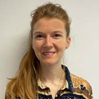 Headshot of a PSHE Association Subject Specialist. She has her hair in a ponytail and is smiling at the camera.